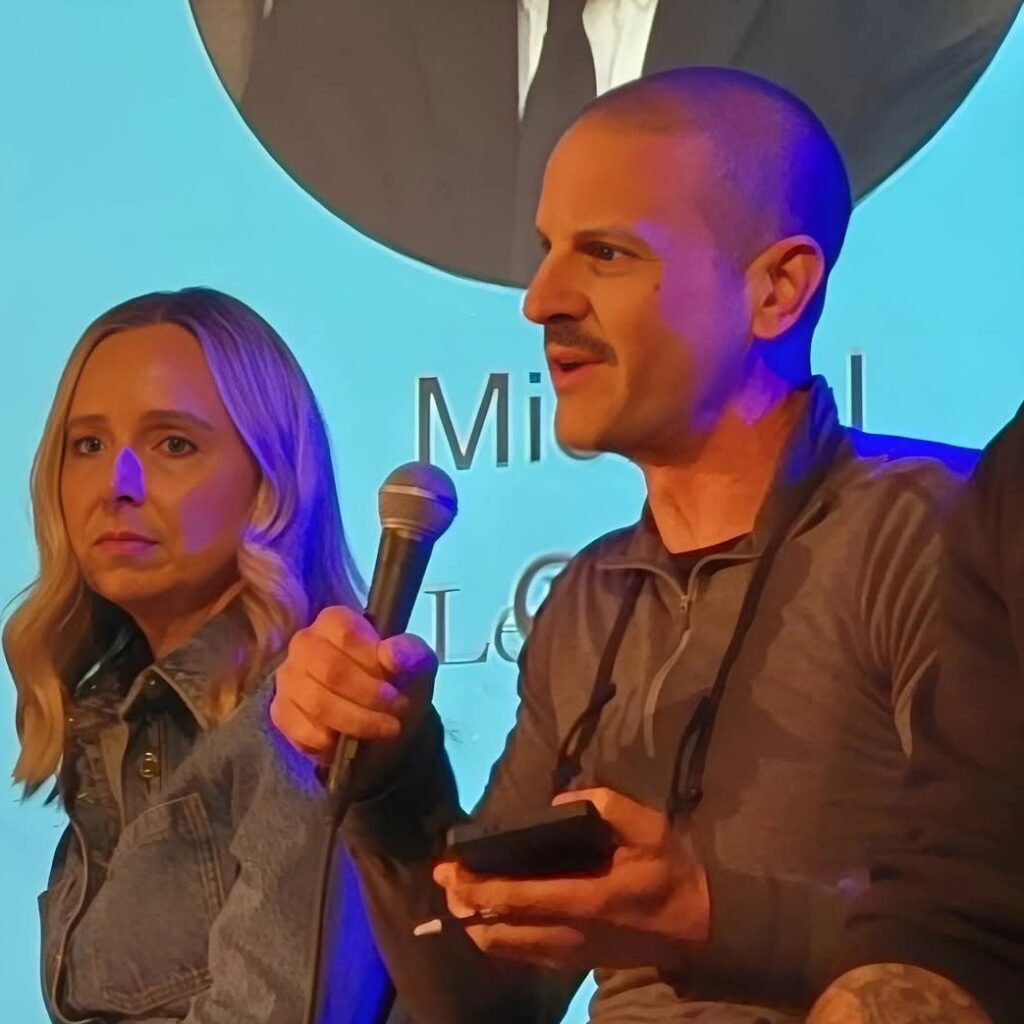 image of derek bicksler on stage speaking on a panel of experts at a brokerage conference