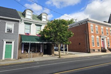 streetscape of a section of S Hanover St in Carlisle, PA near corner of W Chapel Ave and S Hanover ST - sunny spring day in May 2026 with blue skies and white clouds