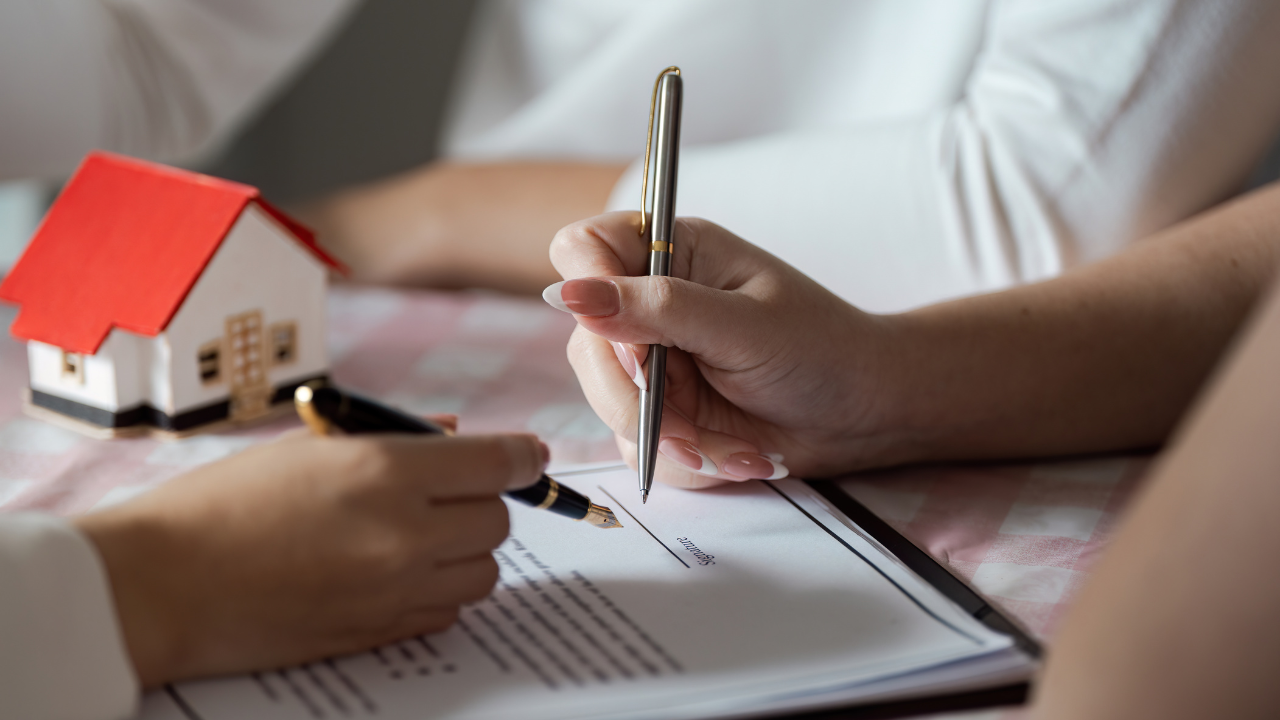 article banner image for 5 Home Listing Documents Every Carlisle Home Seller Must Know: Complete Guide to The Five Most Common Forms, Notices, and Contracts of 2 hands signing a document