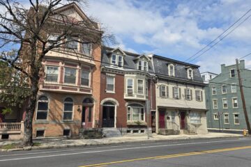a streetscape on s hanover st in carlisle pa on a sunny september day in 2026 with white fluffy clouds