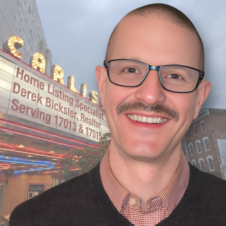 Headshot of derek bicksler top carlisle real estate agent and listing specialist and seller's representative specialist with the carlisle theatre sign in the background