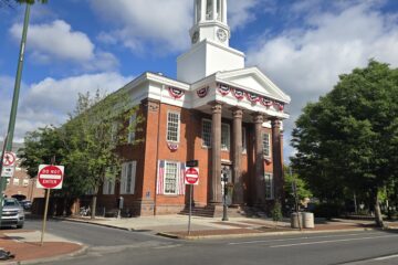 front left angle of the Old Cumberland County Courthouse at 2 Courthouse Square, Carlisle, PA 17013 in August 2026 on sunny day with blue sky and white fluffy clouds