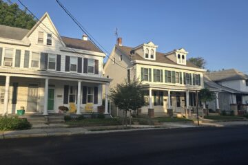 streetscape of homes on n west st in carlisle pa in september 2026 at dusk with clear blue sky